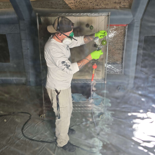 Spray coating firearm parts